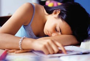 teen sleeping at desk